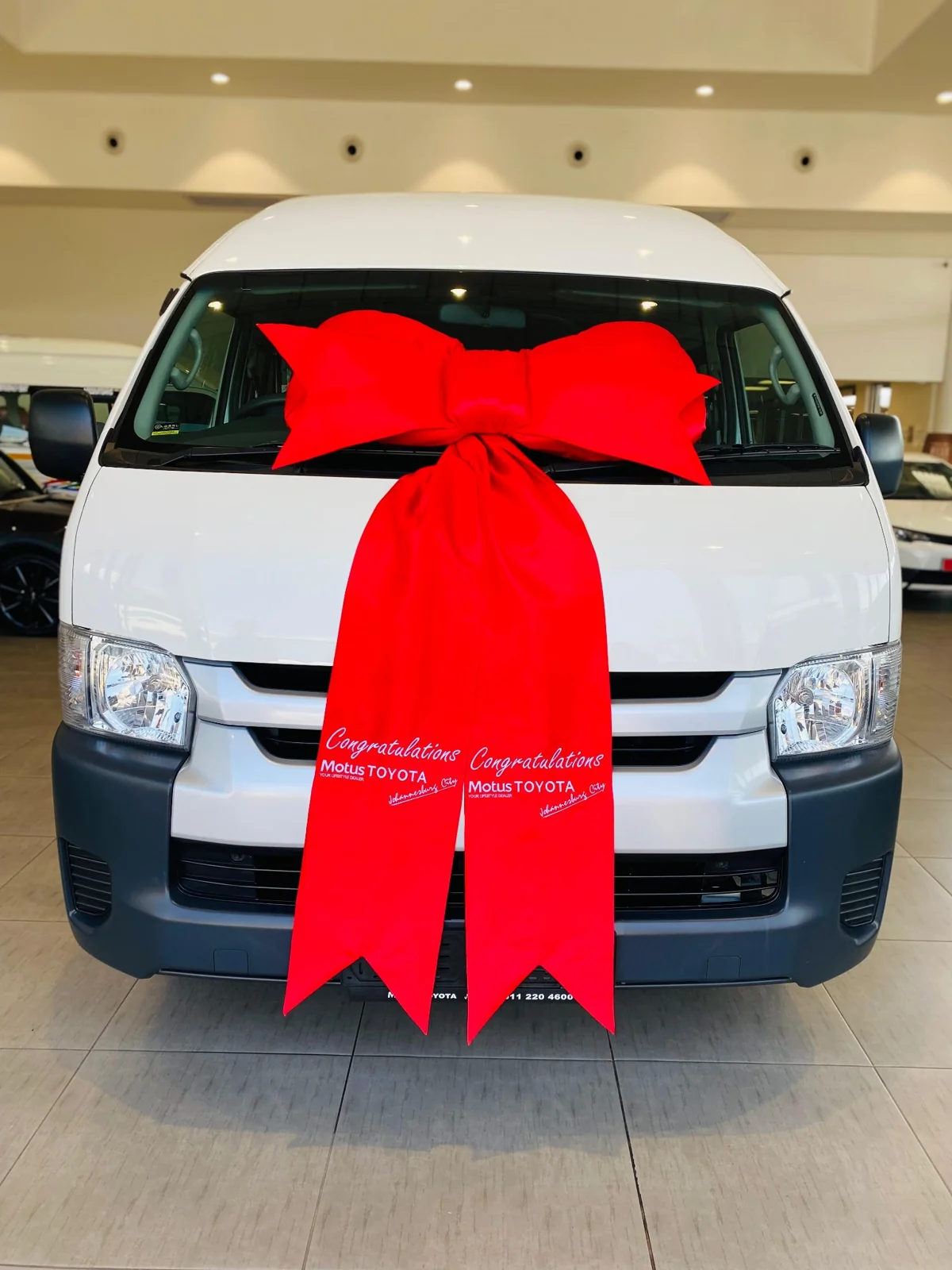 A supplied photograph celebrating a vehicle delivery